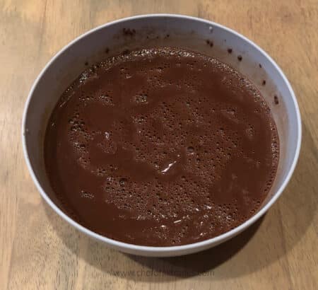cocoa and boiling water mixed together in a bowl