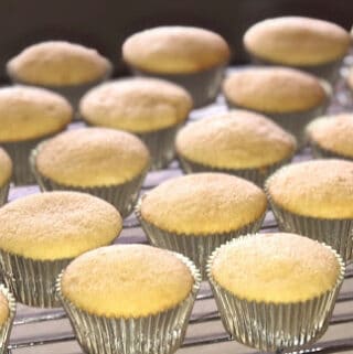 Perfect Vanilla Cake in cupcake form on a cooling rack