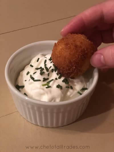 mashed potato bites being dipped in sour cream