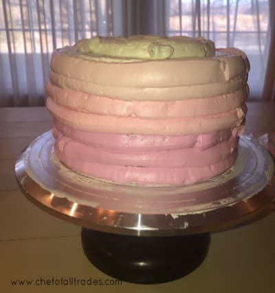 colored buttercream piped on the sides of the cake