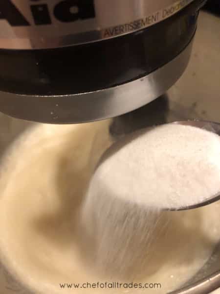Sugar being added to meringue