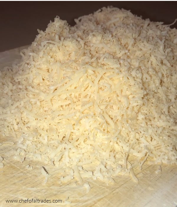 Grated parmesan cheese on a cutting board