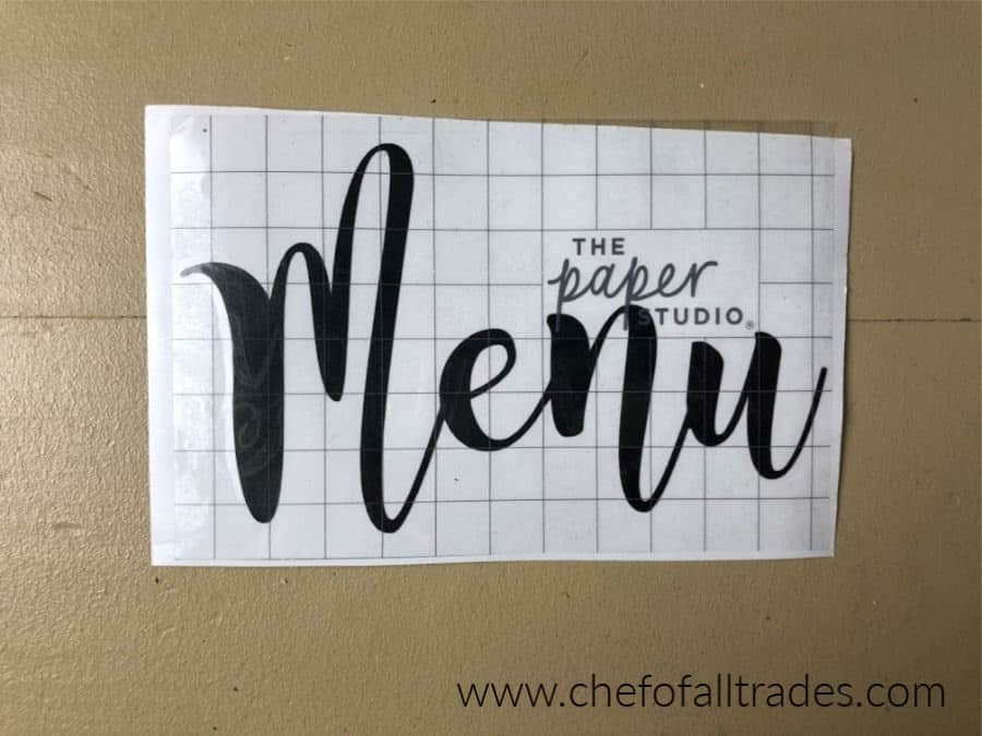 vinyl menu sign with transfer tape placed on top