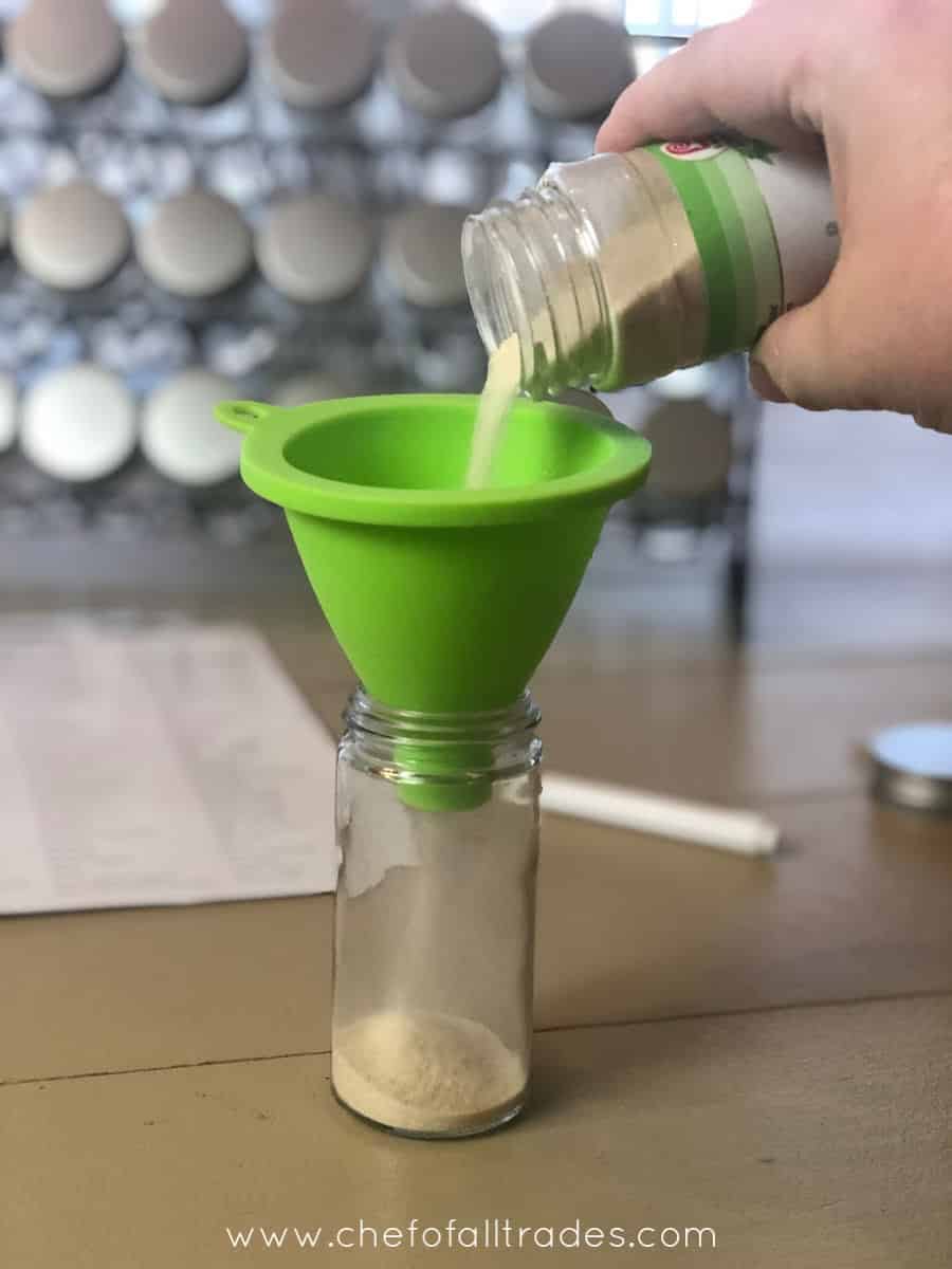 pouring onion powder into glass jar