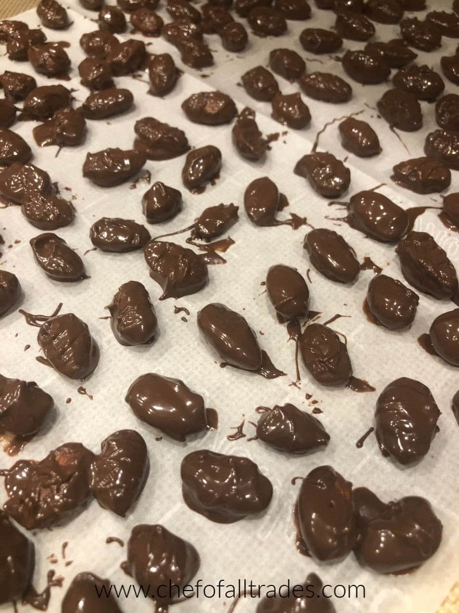 chocolate covered almonds on a cookie sheet