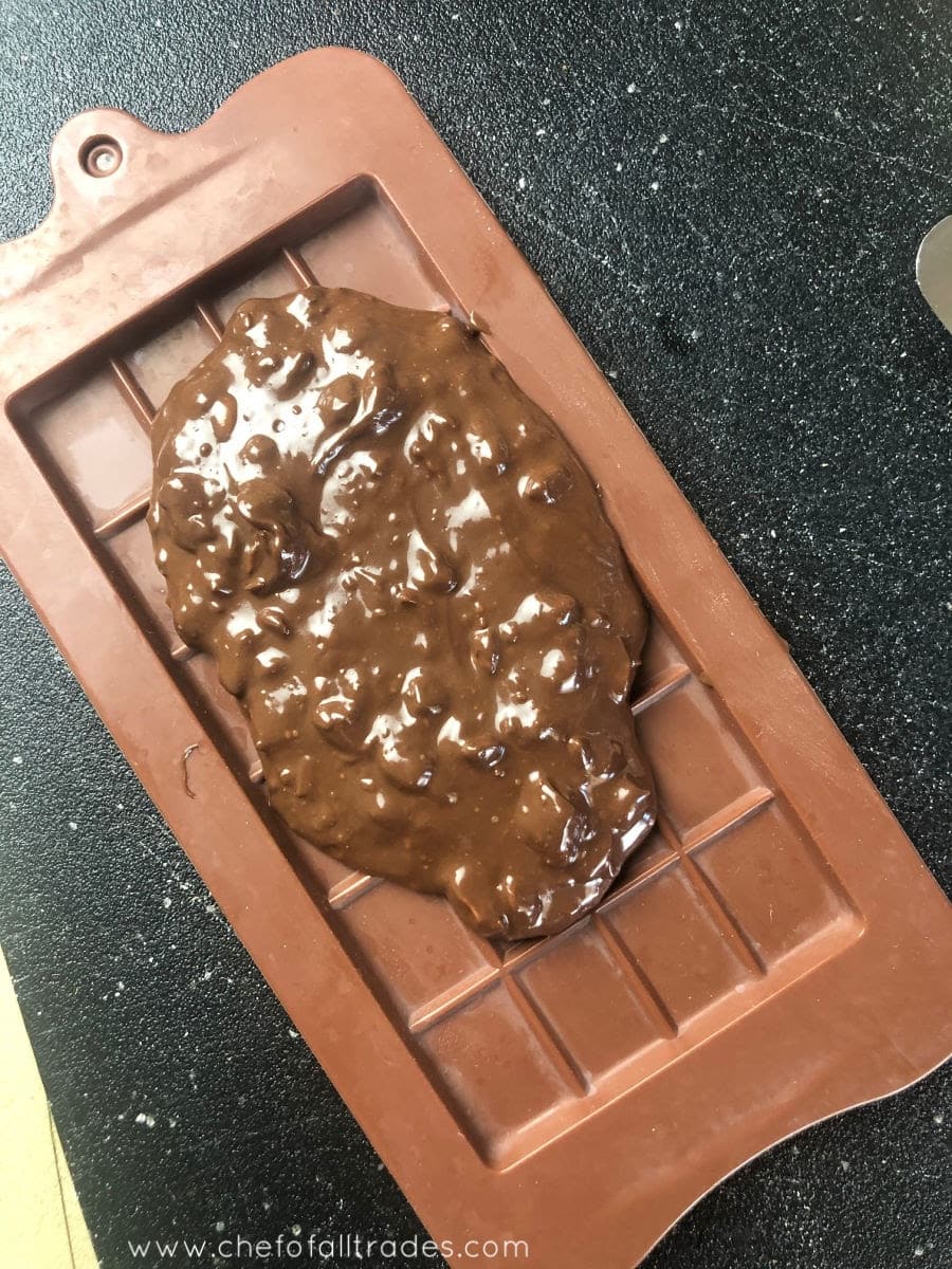 chocolate mixture being added to molds