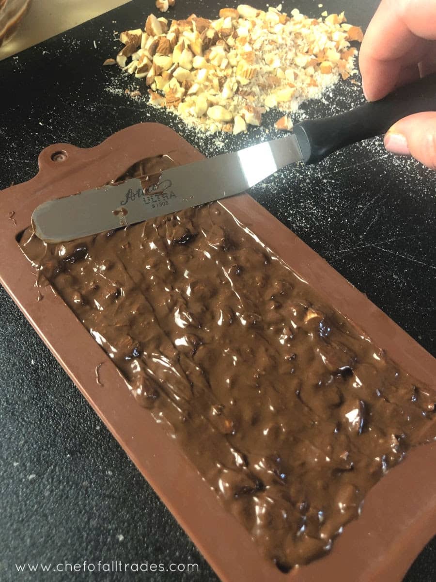 spreading the chocolate mixture into the molds