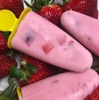 Strawberry Yogurt Pops with strawberries underneath
