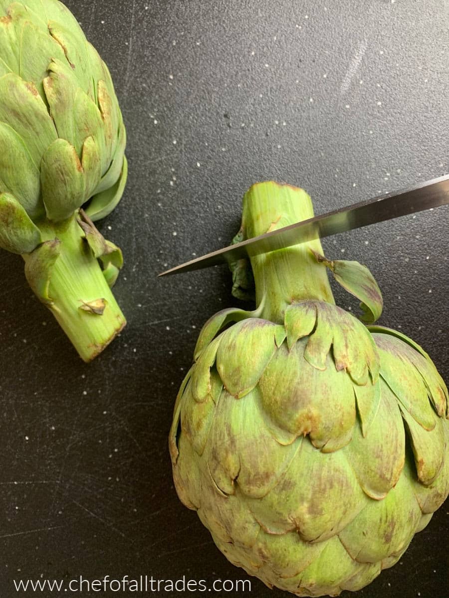 trimming the stocks off the artichokes