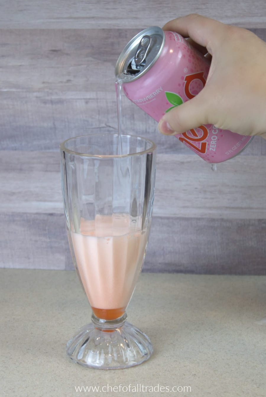 Strawberry Zevia being poured into a glass with the strawberry juice