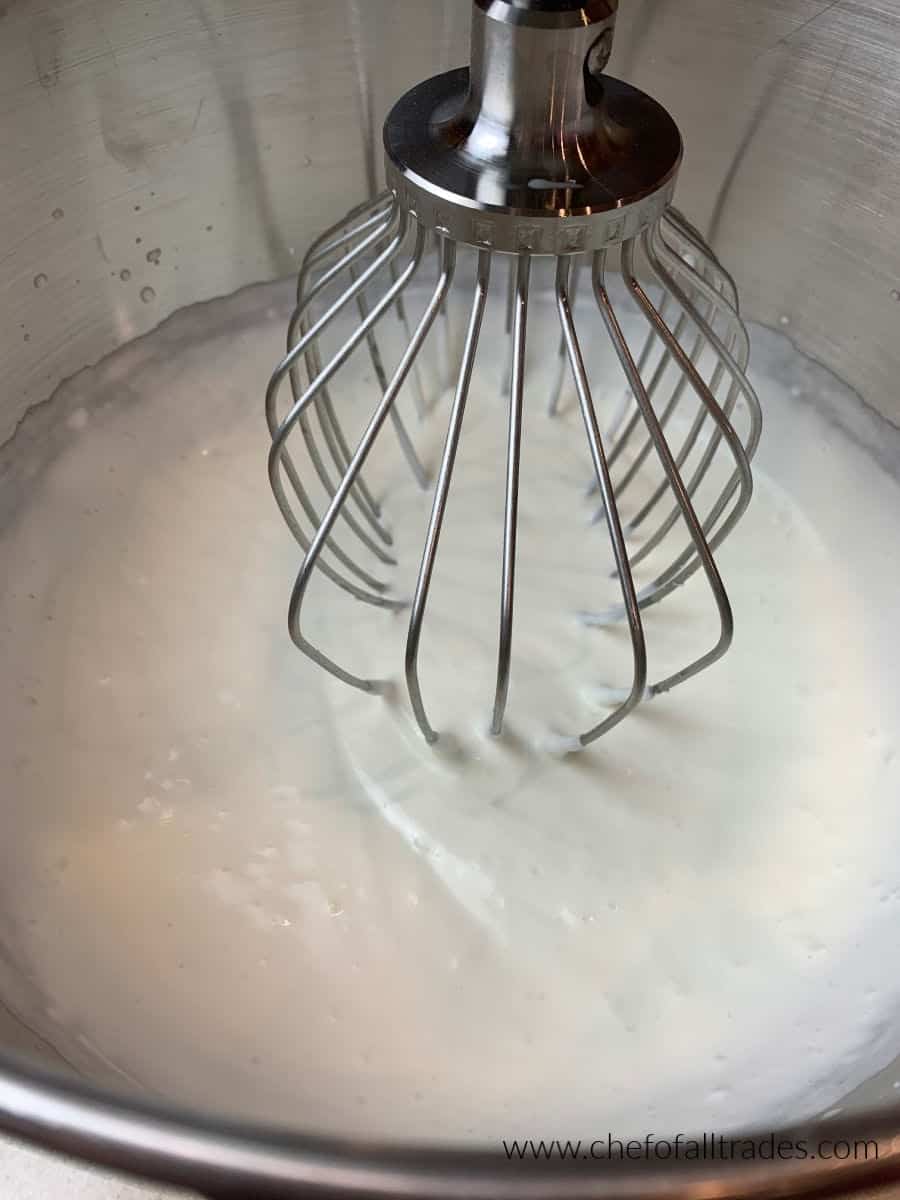 heavy cream whipping in a mixing bowl