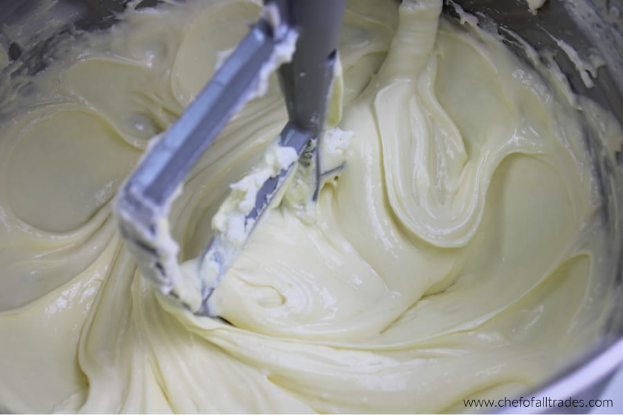 cheesecake batter being whipped in a stand mixer