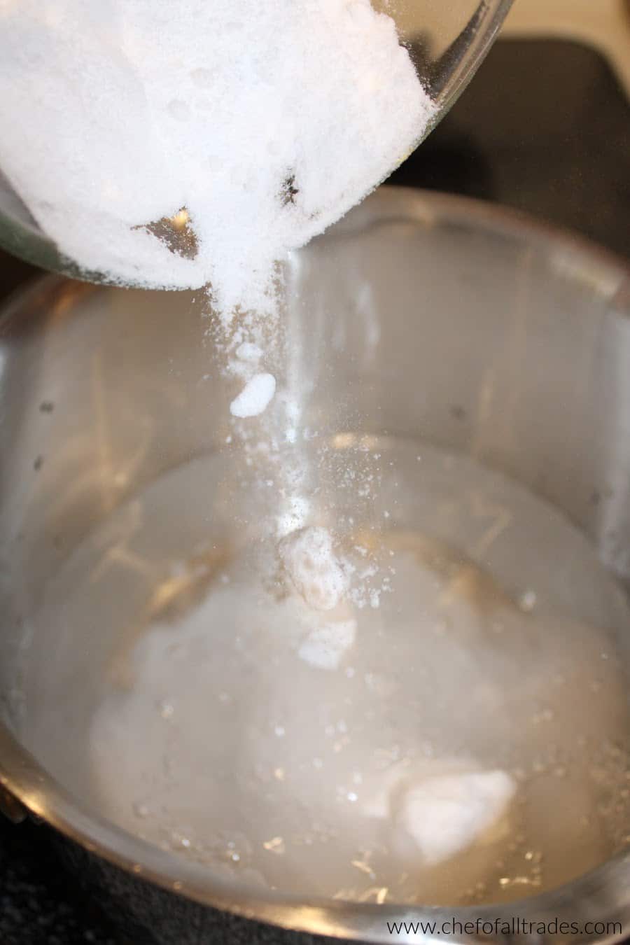 gentle sweet being poured into a pot with water