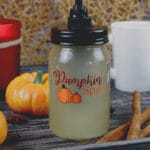 Sugar Free Pumpkin Spice Coffee Syrup in a mason jar with label surrounded by fall decorations