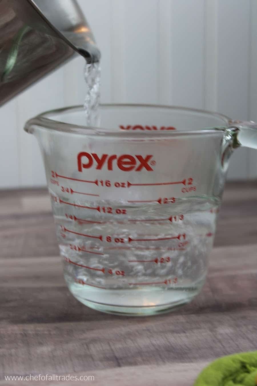 measuring 2 cups of boiling water in a glass measuring cup