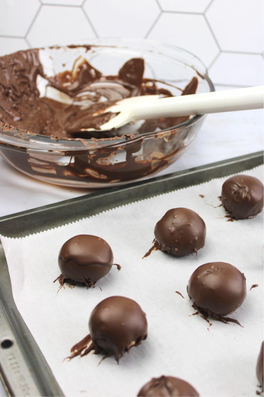 Chocolate Chip Cookie Dough Truffles on a parchment lined cookie sheet
