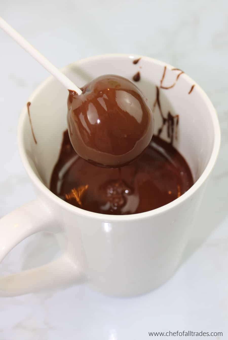 dipping cake pop balls in melted chocolate
