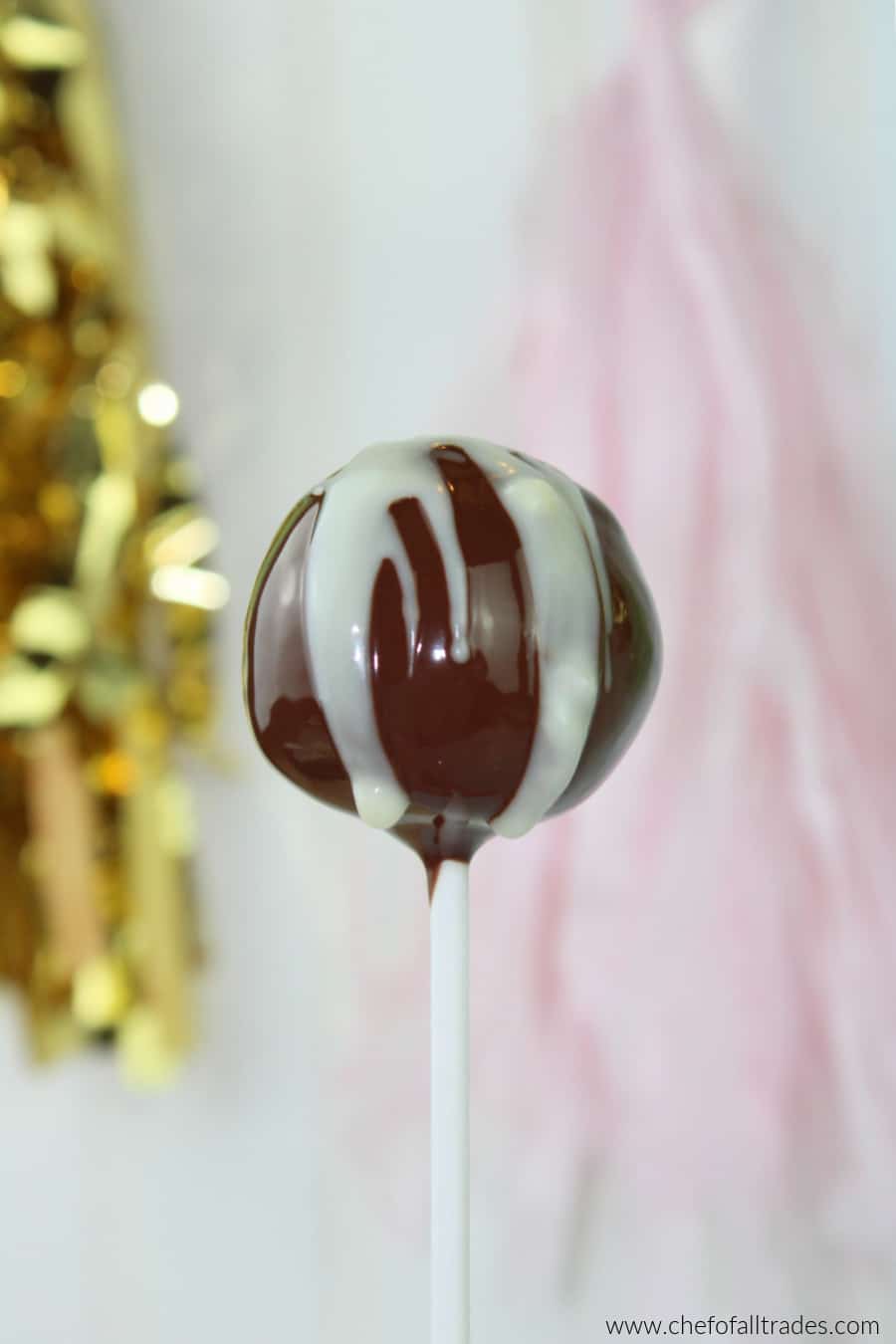 Cake pop against white background with party decorations