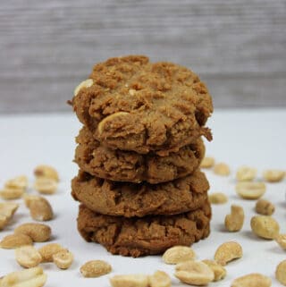 featured stack of peanut butter cookies surrounded by peanuts