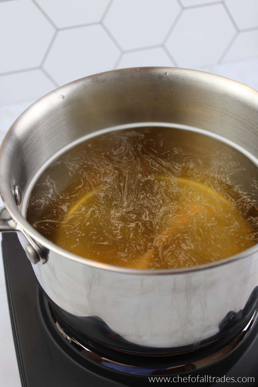 adding the extracts to the water that is in a pot boiling