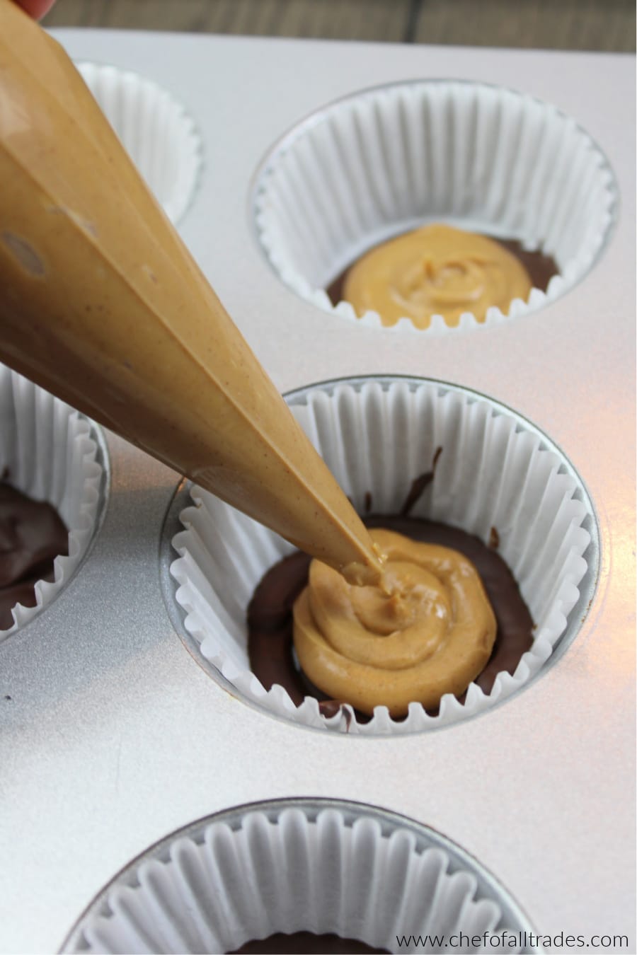 piping peanut butter on top of chocolate bottoms