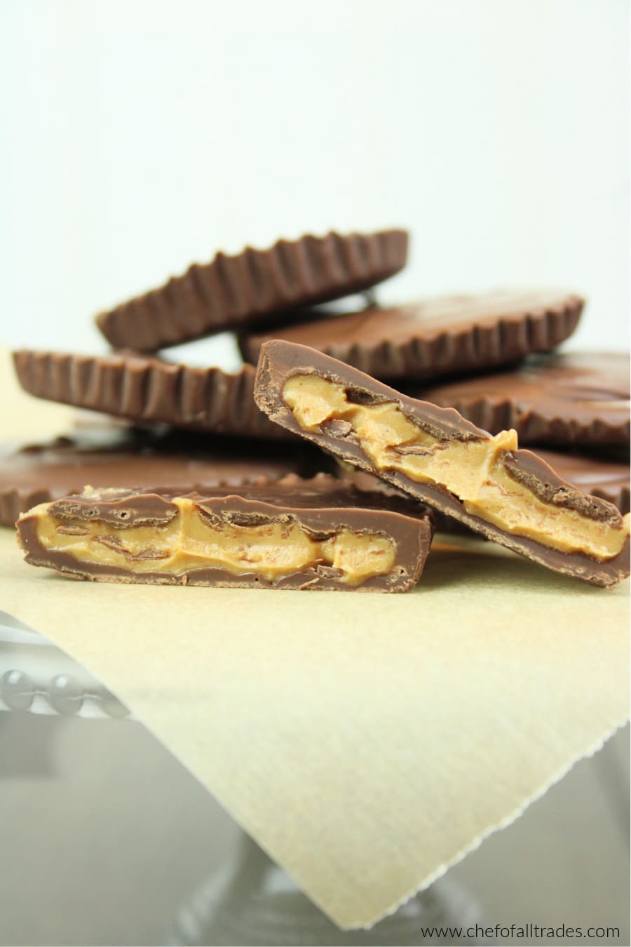 peanut butter cups piled on a parchment paper